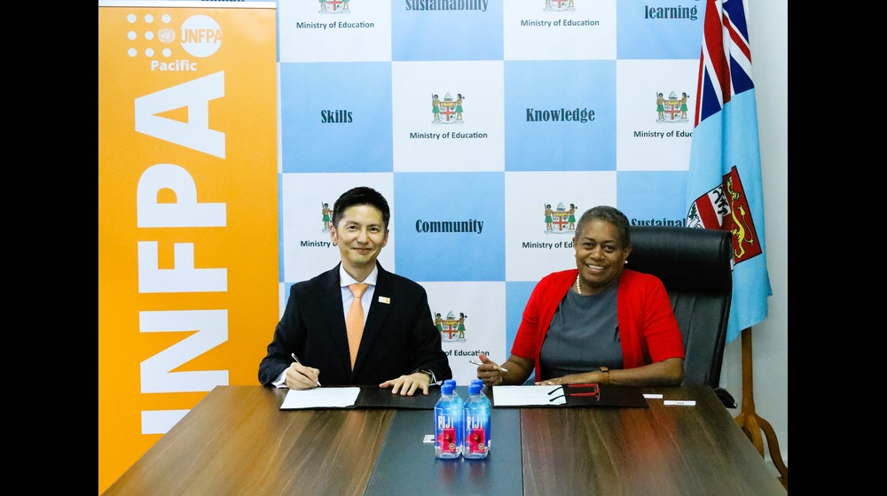 Permanent Secretary for Education, Ms Selina Kuruleca, signing the Implementing Partner Agreement with UNFPA Director for the Pa