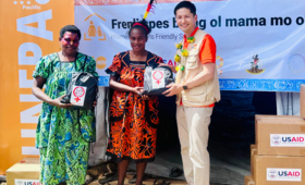 UNFPA Pacific Director, Mr. Iori Kato, handing over the USAID/BHA-supported Menstrual Hygiene Management Kit to community women 