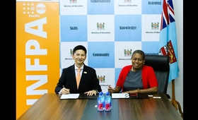 Permanent Secretary for Education, Ms Selina Kuruleca, signing the Implementing Partner Agreement with UNFPA Director for the Pa