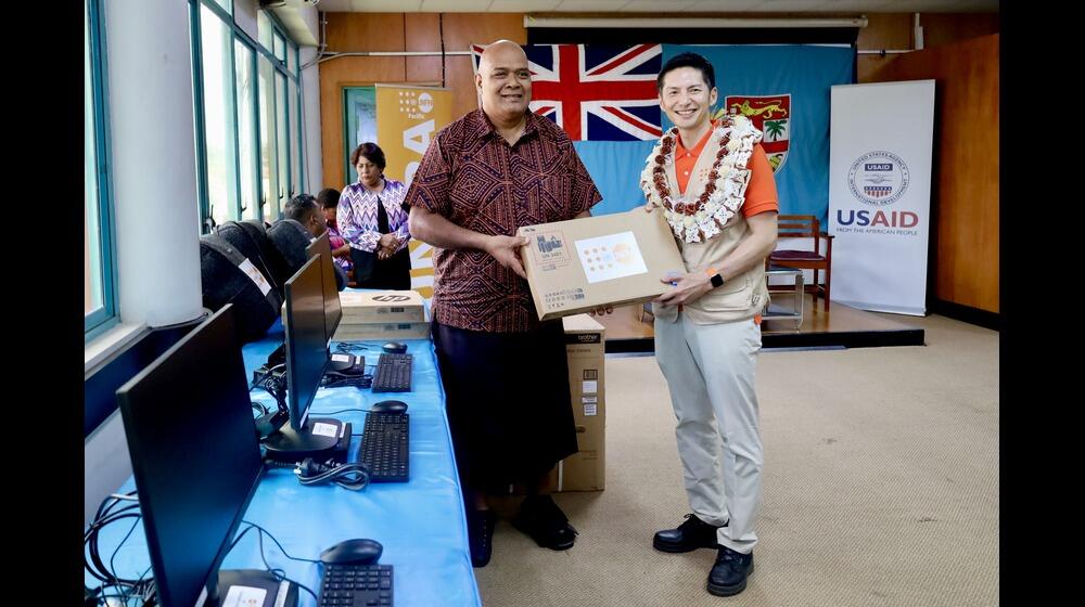 UNFPA Pacific Director, Mr. Iori Kato, handing over IT equipment to Hon. Fiji Northern Division Commissioner, Mr. Uraia Rainima.